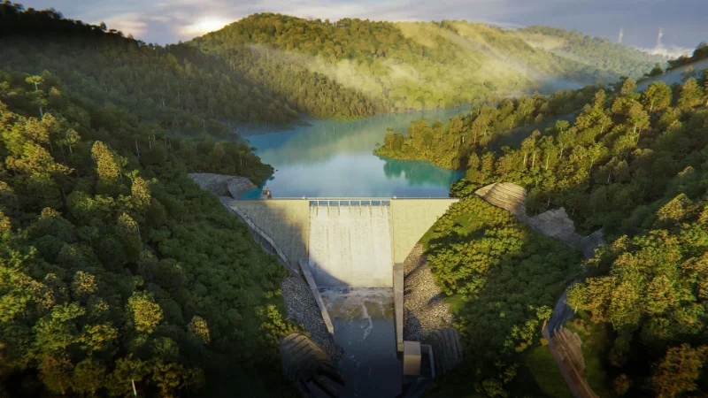 Aerial view of a hydroelectric dam and its reservoir in forested hills
