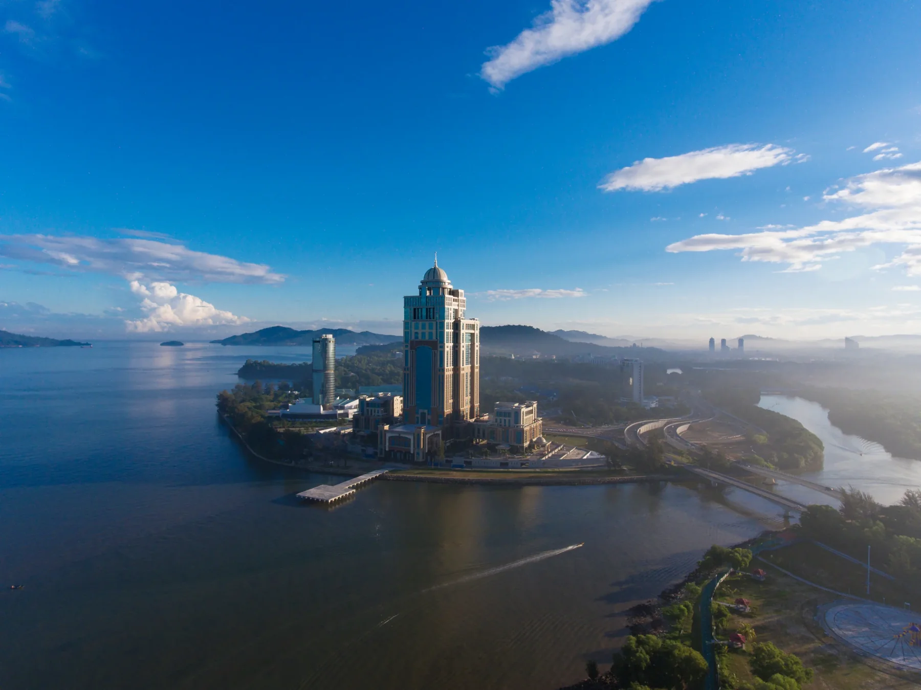 Tun Mustapha Tower on its headland at Kota Kinabalu, photographed from the air across the bay